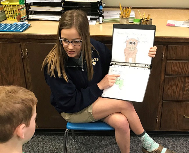 spanish class students read to elementary students